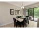 Dining area with a modern table, black leather chairs, and a sliding glass door view of the outdoors at 8219 Roseville Blvd, Davenport, FL 33896