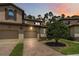 Charming two-story villa with a tile roof, brick driveway, and meticulously landscaped grounds at 8219 Roseville Blvd, Davenport, FL 33896