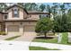 Charming two-story villa with a tile roof, brick driveway, and manicured landscaping at 8219 Roseville Blvd, Davenport, FL 33896