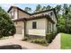 Attractive home exterior with a two-car garage, well-maintained landscaping, and a paved walkway at 8219 Roseville Blvd, Davenport, FL 33896