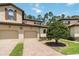 Charming two-story home featuring a two-car garage, a tile roof, and a brick driveway at 8219 Roseville Blvd, Davenport, FL 33896