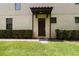 Inviting front door with a covered porch, manicured shrubs, and a well-maintained lawn at 8219 Roseville Blvd, Davenport, FL 33896