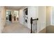Upstairs hallway with laundry closet and neutral carpeting at 8219 Roseville Blvd, Davenport, FL 33896