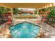 A close view of the community hot tub with lounge chairs, pool, and clubhouse in background at 8219 Roseville Blvd, Davenport, FL 33896