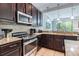Kitchen featuring granite countertops, stainless steel appliances, and mosaic tile backsplash at 8219 Roseville Blvd, Davenport, FL 33896