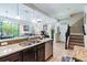 Modern kitchen open to the living area, featuring granite countertops and stainless steel appliances at 8219 Roseville Blvd, Davenport, FL 33896