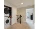 Convenient upstairs laundry closet with stacked washer and dryer at 8219 Roseville Blvd, Davenport, FL 33896