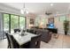 Inviting living room with a decorative ceiling fan, dining area with bright light, and glass doors to the outside at 8219 Roseville Blvd, Davenport, FL 33896