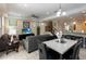 Open living area with living room, dining area, staircase and modern fixtures at 8219 Roseville Blvd, Davenport, FL 33896