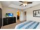 Bright main bedroom with tray ceiling and ensuite bathroom at 8219 Roseville Blvd, Davenport, FL 33896