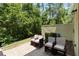 Brick paved patio with outdoor seating, surrounded by green foliage and privacy wall at 8219 Roseville Blvd, Davenport, FL 33896