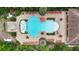 An aerial view of the community pool with lounge chairs, tables, and a separate hot tub area at 8219 Roseville Blvd, Davenport, FL 33896