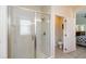 Bright bathroom showcasing a glass-enclosed shower with white tiling and updated fixtures at 8219 Roseville Blvd, Davenport, FL 33896