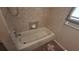 Bathroom featuring a bathtub, sink, and tiled walls at 900 Red Fox Rd, Altamonte Springs, FL 32714