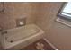 Cozy bathroom featuring a bathtub and tiled walls at 900 Red Fox Rd, Altamonte Springs, FL 32714