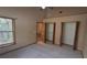 Carpeted bedroom with high ceiling and open closets at 900 Red Fox Rd, Altamonte Springs, FL 32714