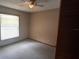 Carpeted bedroom with ceiling fan and bright window at 900 Red Fox Rd, Altamonte Springs, FL 32714