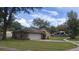 Brick home with a two-car garage, side lawn, and a driveway, offering a glimpse of the neighborhood at 900 Red Fox Rd, Altamonte Springs, FL 32714