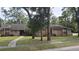Charming brick home featuring a well-maintained lawn, mature trees, and a cozy front entryway at 900 Red Fox Rd, Altamonte Springs, FL 32714