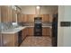 Functional kitchen with light wood cabinets, tile countertops, and black appliances at 900 Red Fox Rd, Altamonte Springs, FL 32714