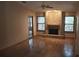 Spacious living room with hardwood floors, a brick fireplace, and vaulted ceiling, filled with natural light at 900 Red Fox Rd, Altamonte Springs, FL 32714
