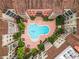 Aerial view of a community pool surrounded by lush landscaping and charming buildings at 911 N Orange Ave # 335, Orlando, FL 32801