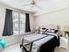 Cozy bedroom with hardwood floors, neutral walls, curtains, a large window and a ceiling fan at 911 N Orange Ave # 335, Orlando, FL 32801