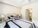 Comfortable bedroom featuring a ceiling fan, a large bed, and a doorway to the bathroom at 911 N Orange Ave # 335, Orlando, FL 32801