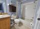 Well-lit bathroom showcasing a tiled shower and tub combination, toilet and vanity at 1022 Calabria Ave, Davenport, FL 33897