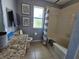 Cozy bathroom with gray walls, a shower over tub, and natural light at 1022 Calabria Ave, Davenport, FL 33897