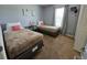 Guest bedroom featuring twin beds, gray walls, carpet, and a window at 1022 Calabria Ave, Davenport, FL 33897