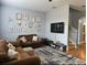 Cozy living room featuring hardwood floors, neutral paint and decor, and stairway to the second floor at 1022 Calabria Ave, Davenport, FL 33897