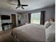 Main bedroom with neutral carpet, a ceiling fan, and a window view to the outside at 1022 Calabria Ave, Davenport, FL 33897