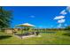 Scenic picnic area with a gazebo, picnic table, and community grill overlooking a pond at 1022 Calabria Ave, Davenport, FL 33897