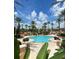 Picturesque pool area with palm trees, lounge chairs, and tropical foliage at 1022 Calabria Ave, Davenport, FL 33897
