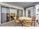 The covered outdoor balcony with a table and chairs is ideal for entertaining at 1100 Sunset View Cir # 204, Reunion, FL 34747