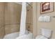 Bathroom featuring a shower/tub combo, tile flooring, and neutral-colored walls at 1100 Sunset View Cir # 204, Reunion, FL 34747