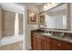 Bathroom featuring a vanity with granite counters, an oversized mirror, and a shower/tub combo at 1100 Sunset View Cir # 204, Reunion, FL 34747