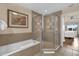 Updated bathroom with a glass door shower and garden tub at 1100 Sunset View Cir # 204, Reunion, FL 34747
