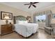 Comfortable bedroom featuring a plush bed, ceiling fan, and nice view from the window at 1100 Sunset View Cir # 204, Reunion, FL 34747