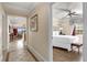 Relaxing bedroom featuring a plush bed, ceiling fan, and views from the window at 1100 Sunset View Cir # 204, Reunion, FL 34747