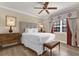 Bedroom featuring a ceiling fan, hardwood floors, neutral paint, and natural light from the window at 1100 Sunset View Cir # 204, Reunion, FL 34747