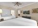Cozy bedroom offering two beds, wood-look floors, and a TV at 1100 Sunset View Cir # 204, Reunion, FL 34747