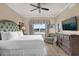 Comfortable bedroom with wood-look floors, ceiling fan, and a TV at 1100 Sunset View Cir # 204, Reunion, FL 34747