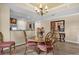 Dining area featuring a decorative chandelier, round glass-top table and four chairs, and an open floorplan at 1100 Sunset View Cir # 204, Reunion, FL 34747