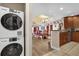 Open concept kitchen with laundry appliances, stainless appliances, view to the living room at 1100 Sunset View Cir # 204, Reunion, FL 34747