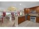 Open concept kitchen with stainless appliances, granite counters, and breakfast bar connecting to the living area at 1100 Sunset View Cir # 204, Reunion, FL 34747