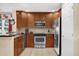 Kitchen featuring stainless steel appliances, tile backsplash, and abundant wooden cabinet space for storage at 1100 Sunset View Cir # 204, Reunion, FL 34747
