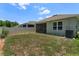 Spacious backyard with well-maintained lawn, screened patio, and privacy fence at 1287 Berry Ln, Davenport, FL 33837