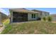 Spacious backyard with grass, screened patio, and privacy fence perfect for outdoor entertaining at 1287 Berry Ln, Davenport, FL 33837